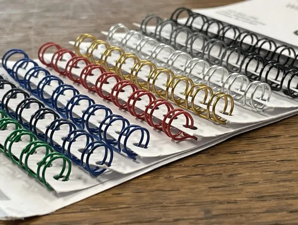 Wire-O binding wire in multiple colors including black, white, silver, blue, red, and gold